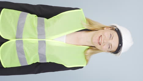 Vertical-video-of-The-engineer-wearing-a-hard-hat-and-smiling.